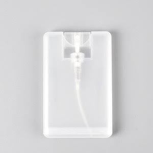 Hand holding CLARO travel size lens cleaner spray bottle